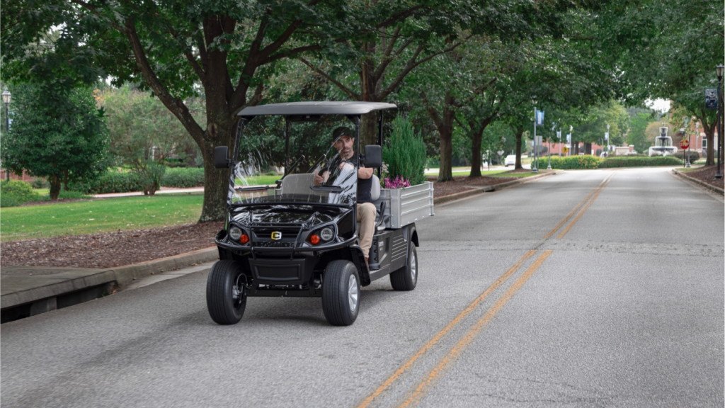 Hauler XL LSV driving on a path under trees