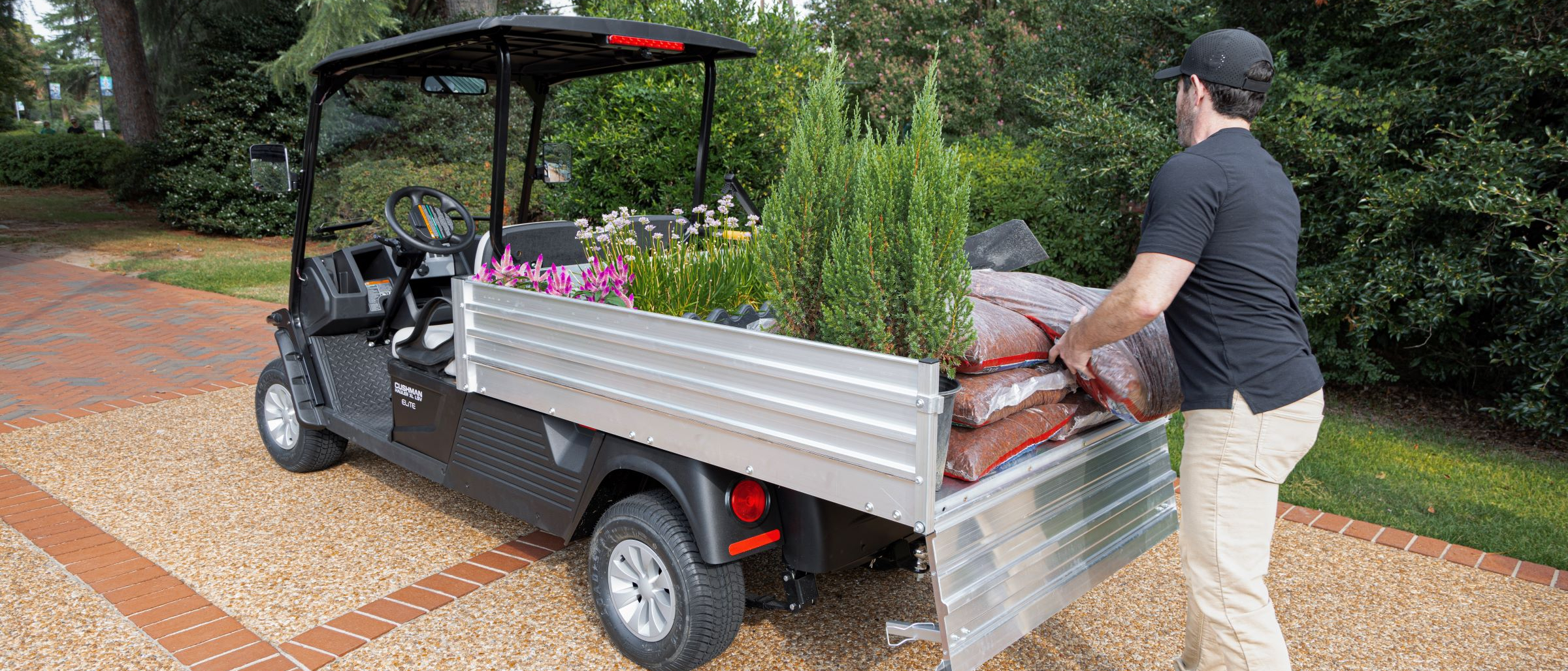Cushman Hauler XL LSV on campus unloading bed of truck
